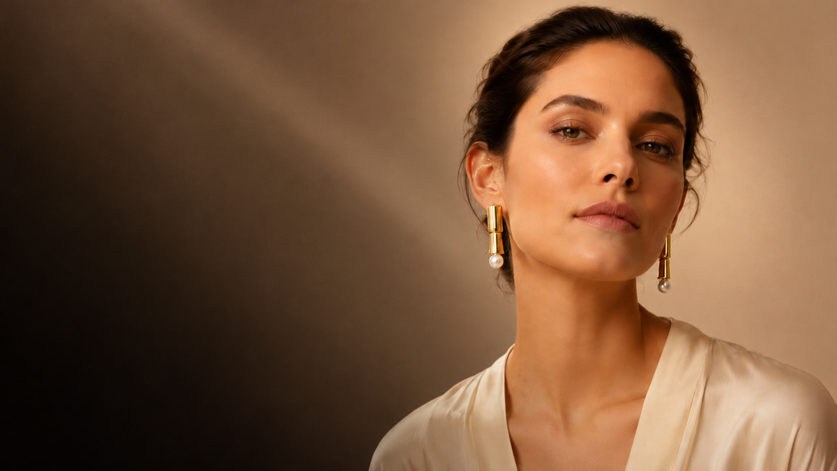 Woman wearing 18K gold-plated drop earrings by DIOLYSH — anti-tarnish, hypoallergenic everyday jewellery